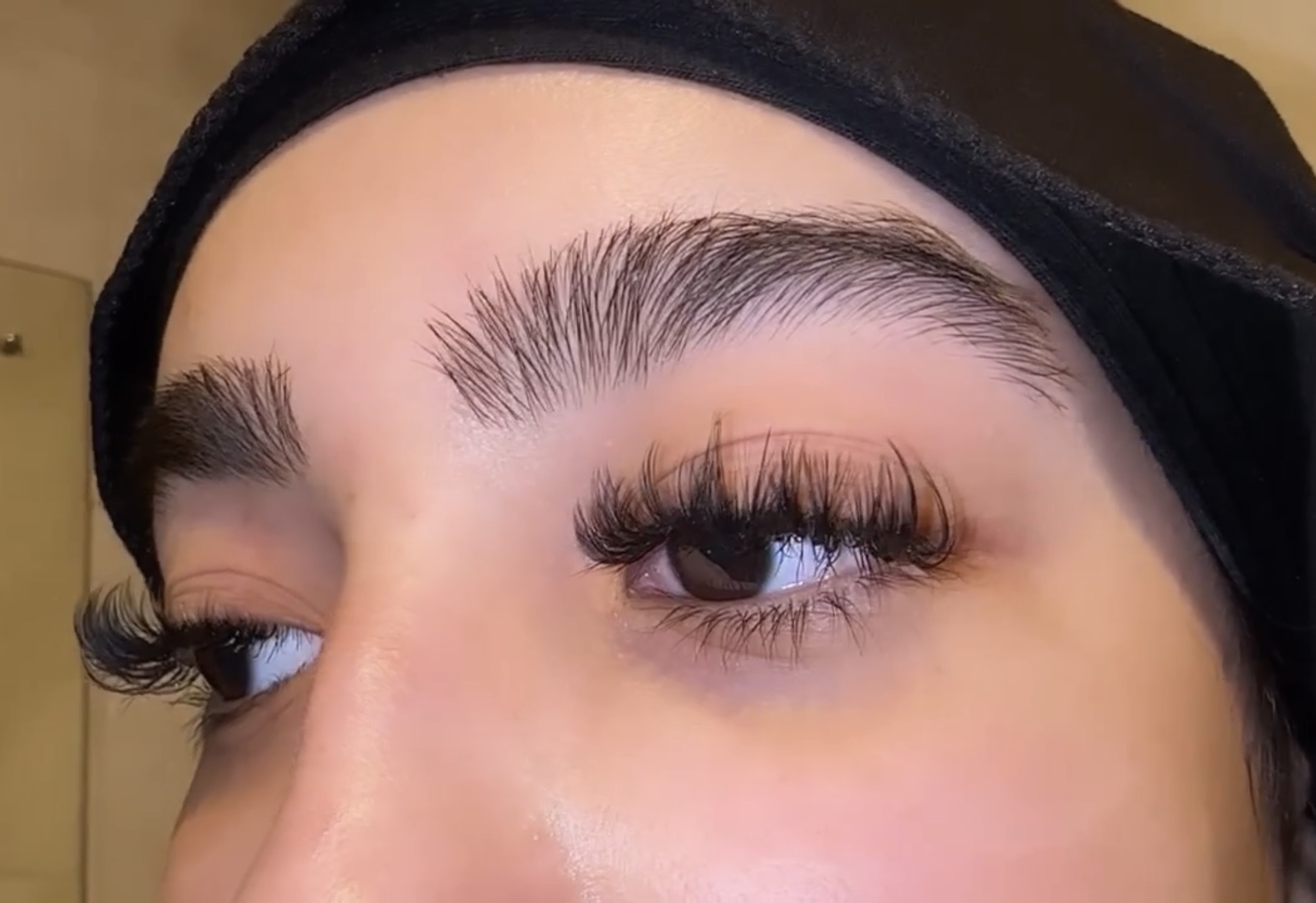 Open brown eye showing fluffy volume lashes