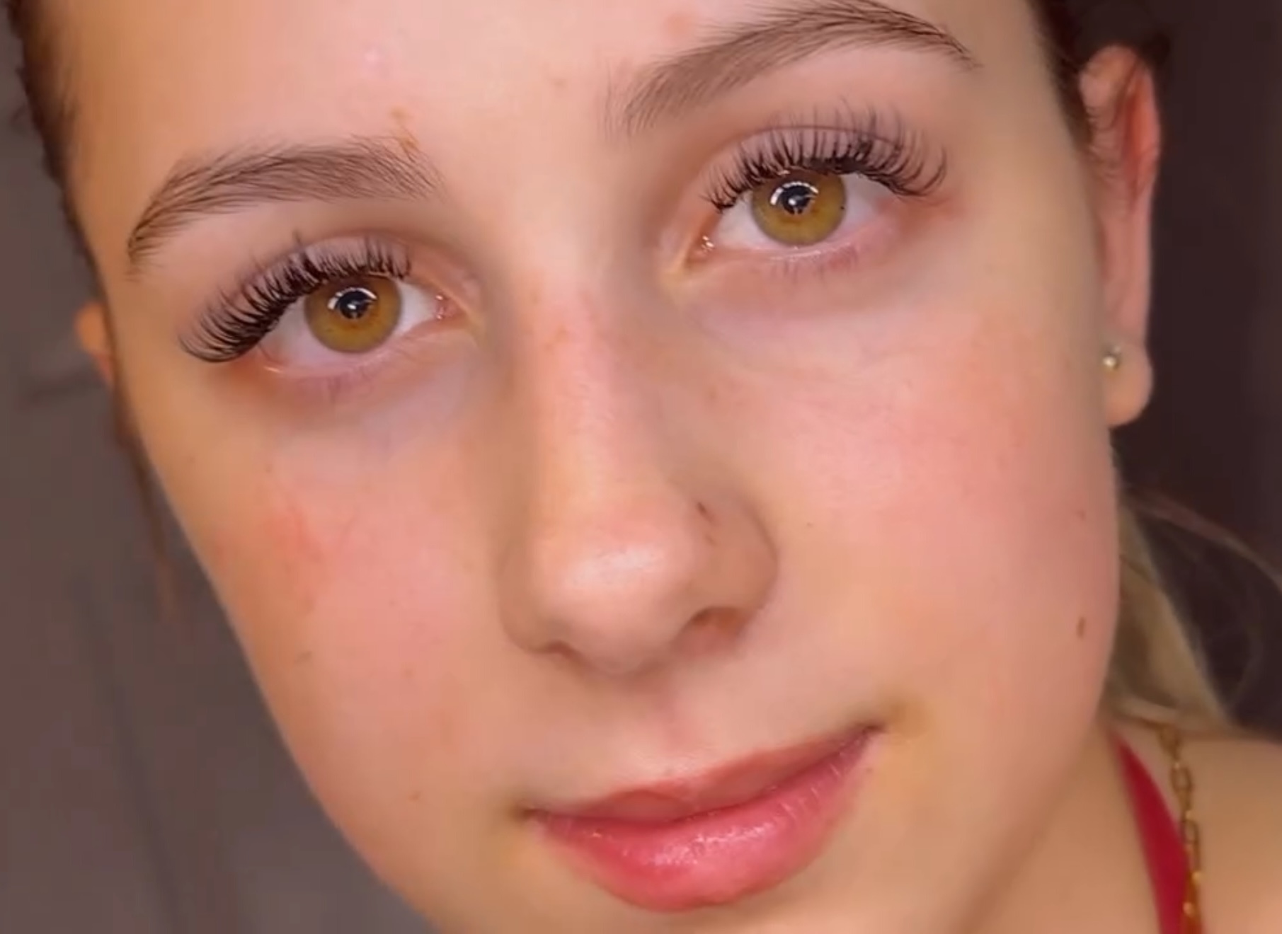 Natural lash extension look on a blonde client with freckles